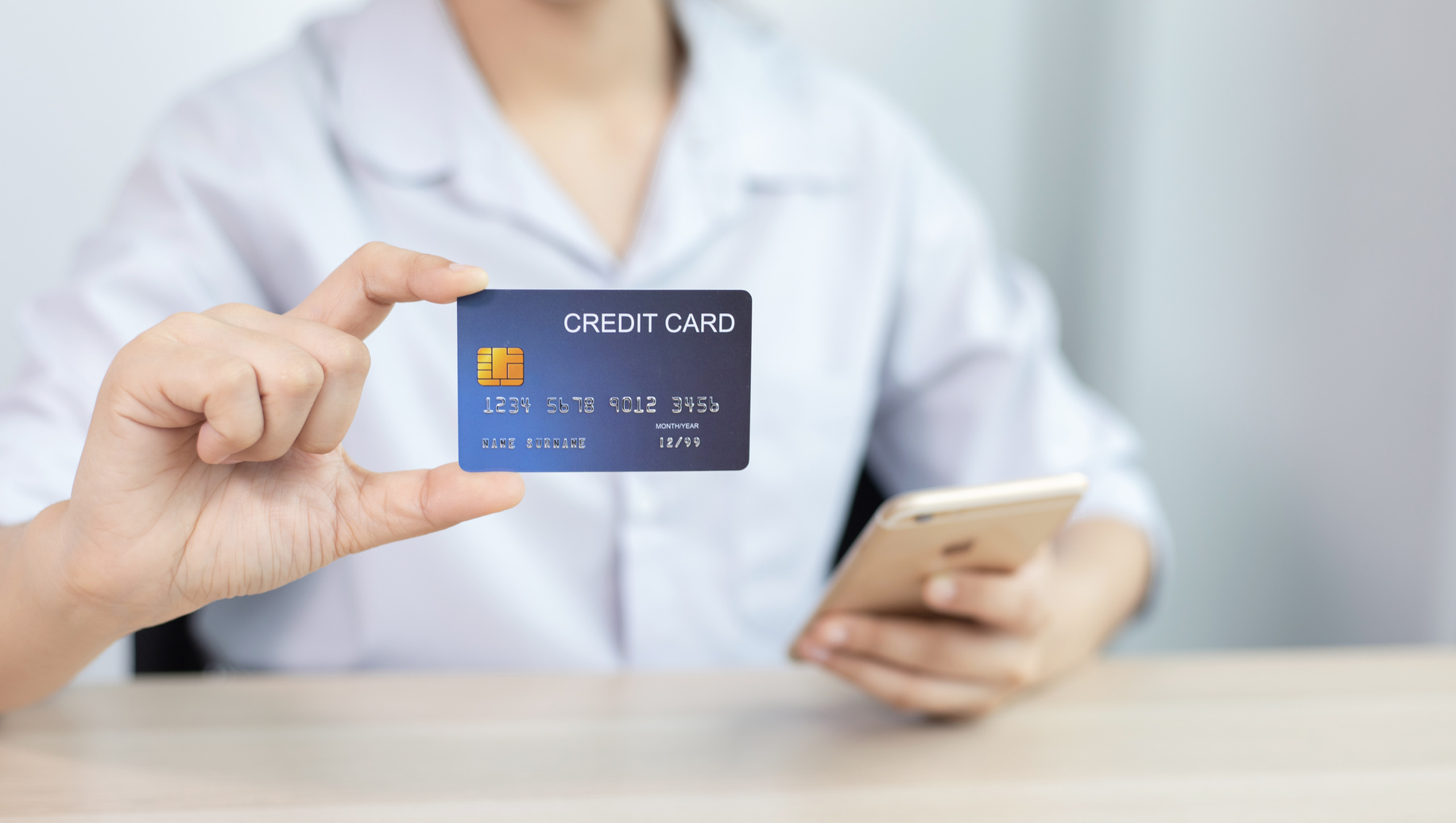 Person Using Credit Card To Purchase Online Orders